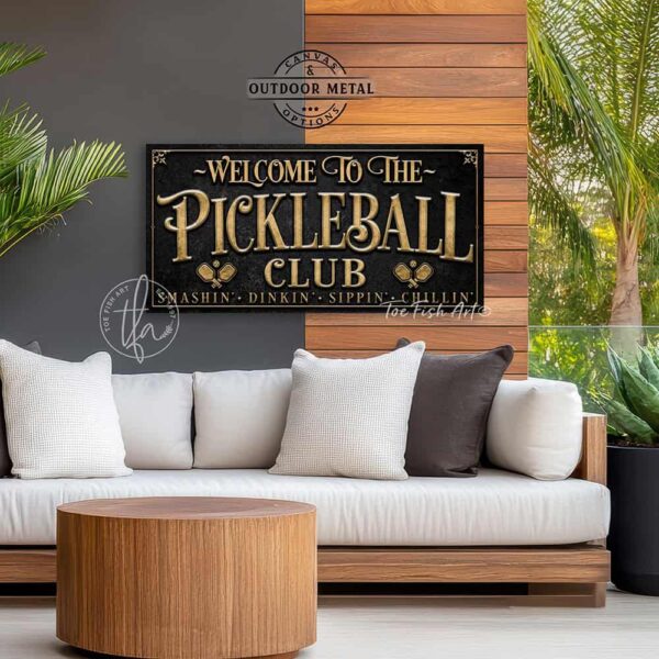 Toe Fish Art’s personalized "Pickleball Club” sign features the phrase "Smashin' Dinkin' Sippin' Chillin’" in rustic gold style lettering on a vintage slate black background. Available as a beautiful framed canvas sign or durable and sleek outdoor metal sign, this custom wall art decor adds humor and charm to your game space or post-play lounge area. Made in America and built to last, perfect for pickleball lovers, sports decor, and custom man cave or backyard court accents. This premium printed sign showcases a detailed, original design ideal for upgrading your sports bar, game room, court-side seating, outdoor entertaining space, or backyard decor. Customized sign, personalized with family name or favorite saying and custom wording options. Available in a huge array of sizes, Toe Fish Art's artisan-made wall decor is expertly made in America with American-sourced materials. This high-end, handcrafted piece can be customized to fit your style! Built to last with genuine craftsmanship, this heirloom decor adds rustic cottage charm and heritage quality to any space. Made in the USA with durable, authentic materials for a beautiful and meaningful display to last year after year. Modern Farmhouse Cottagecore wall decor handcrafted in durable high-quality framed canvas or indoor-outdoor weatherproof solid aluminum metal, handmade in the USA from start to finish! Beautiful, stylish and timeless wall decor artwork. Handmade in the USA by ToeFishArt, and built to last a lifetime by the Toe Fish Art family artisans. This beautiful original artwork adds unique eye-catching decor indoors or outdoors. Perfect for your game room, man cave, sports bar post-game lounge, basement bar, garage bar, patio, lanai, deck, or any outdoor living space. This special decoration is a fun way to celebrate your favorite game with friends. Original, custom, personalized wall decor signs. Canvas, Wood or Metal. Rustic modern farmhouse, cottagecore, vintage, retro, industrial, Americana, primitive, country, coastal, minimalist. Toe Fish Art is a USA small family woman owned business making beautiful decor since 1997.